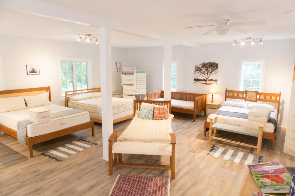 Free Image of Modern bedroom setup featuring various styles of beds in a bright space 