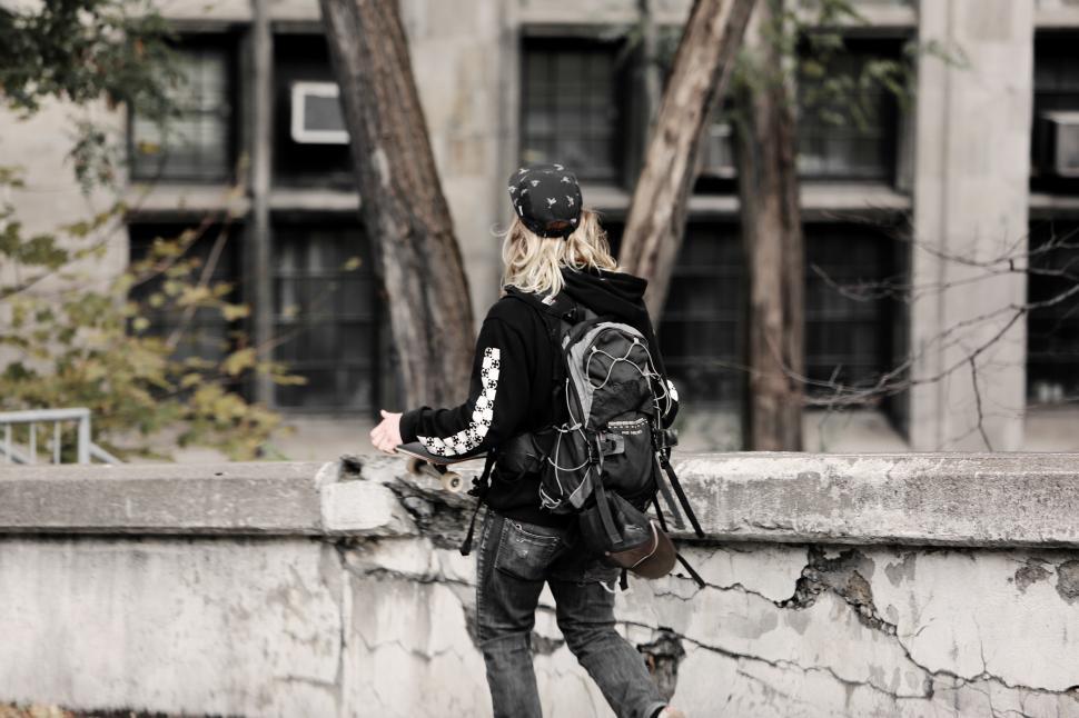 Free Image of Skateboarder exploring urban landscape in autumn 