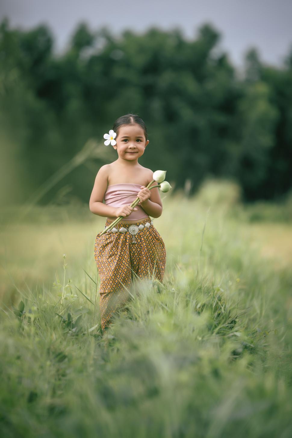 Free Image of Cute girls in Thai traditional dress standing in rice field 