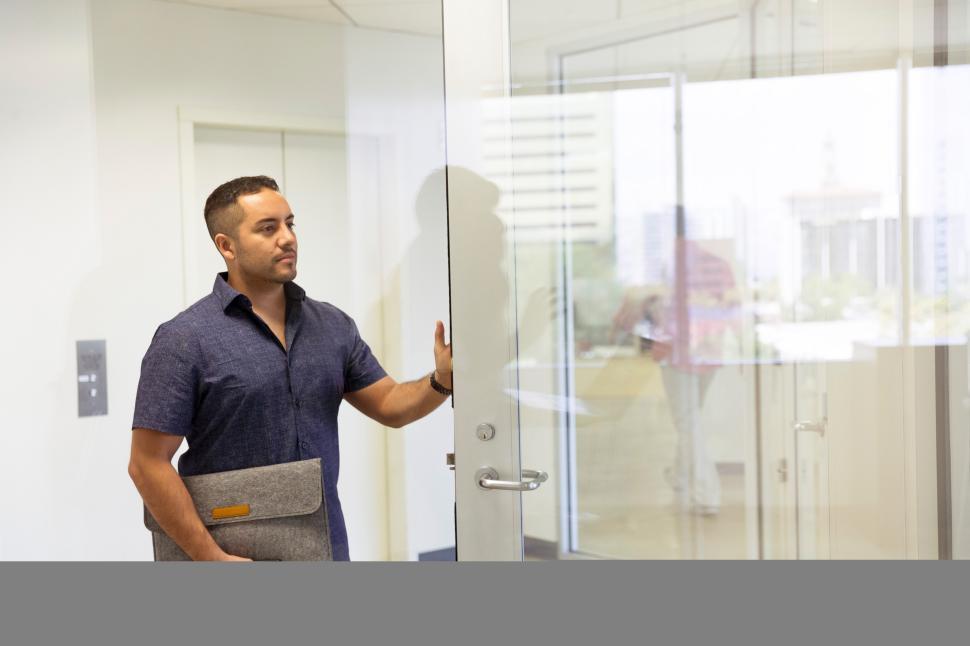 Free Image of Business professional entering modern office space 
