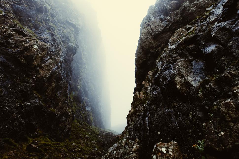 Free Image of Misty canyon revealing rocky cliffs and shadows 