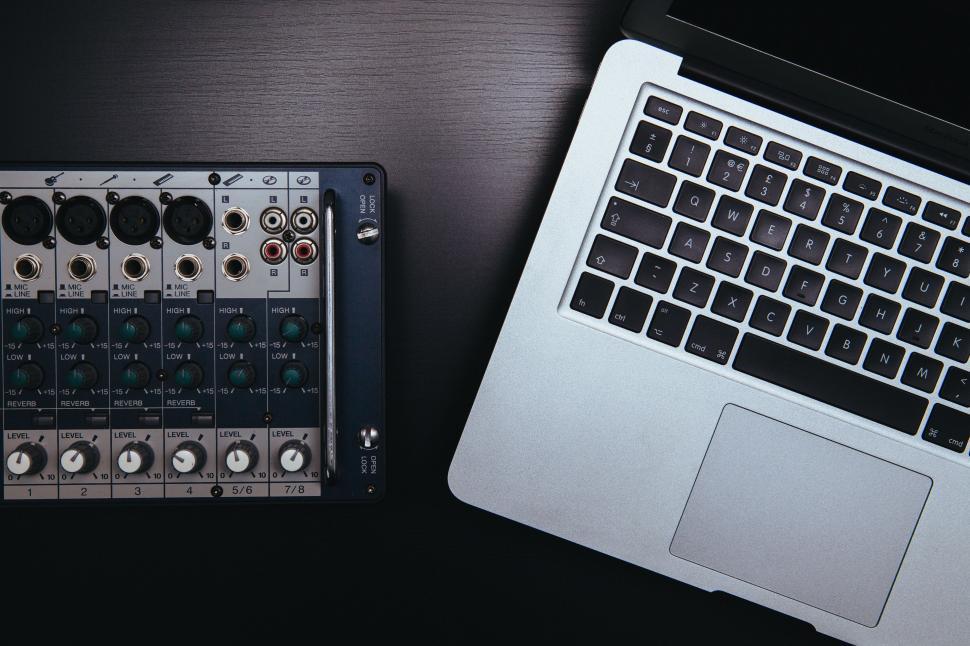 Free Image of Mixing equipment beside a laptop in a creative workspace 