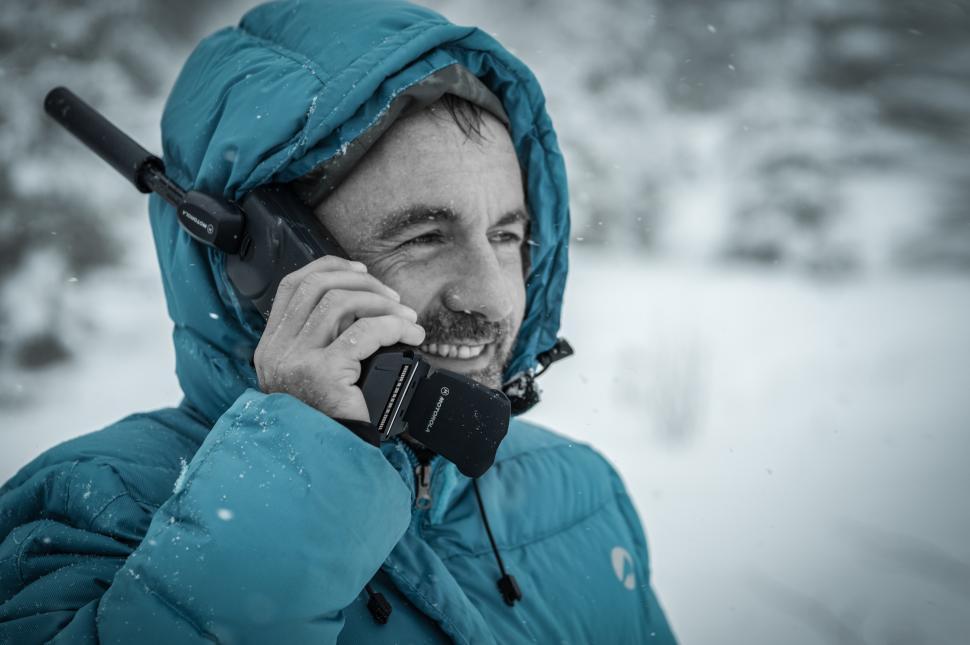 Free Image of Man communicates via radio in snowy landscape 