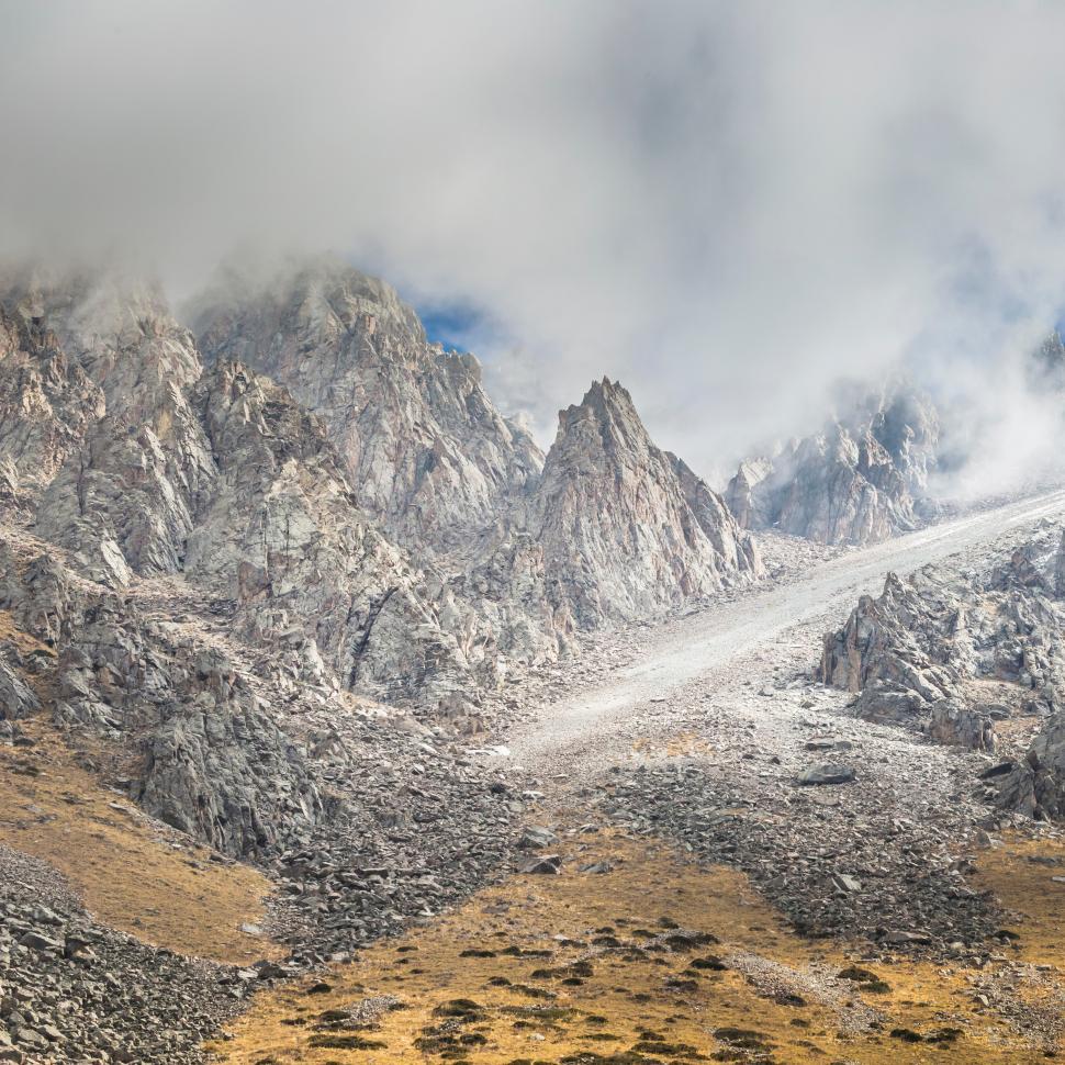Free Image of Stunning rocky landscape showcasing rugged mountains and soft clouds 