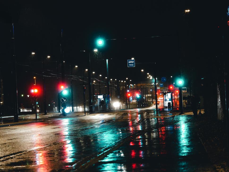 Free Image of City street at night with illuminated traffic signals 