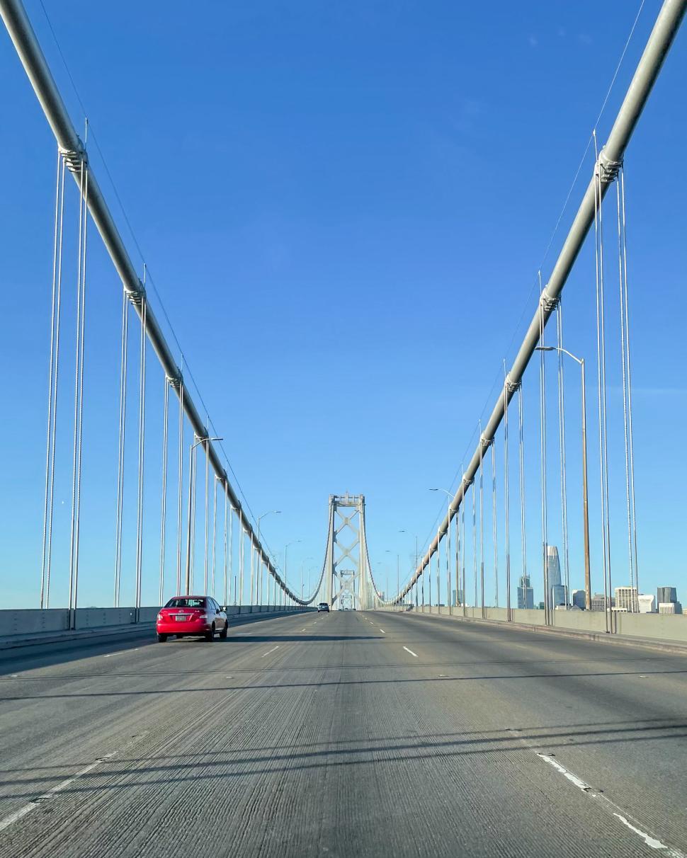 Free Image of Driving across a modern suspension bridge on a clear day 
