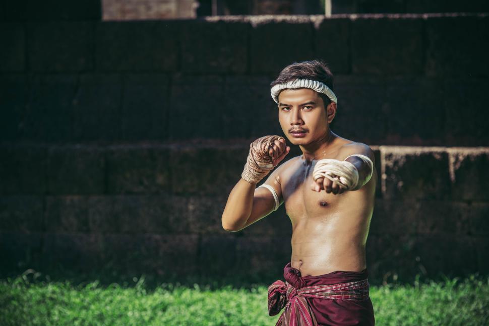 Free Image of A boxer tied a rope in his hand and performed a fight, The martial arts of Muay Thai. 
