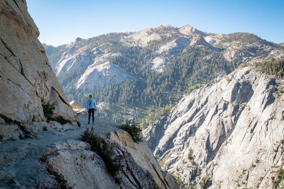 Free Image of Hiker explores rocky trail with mountain views in national park 