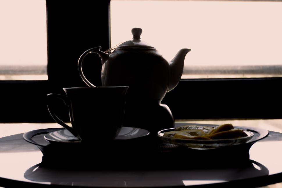 Free Image of Silhouette of a teapot and cup with lemon on a tray  