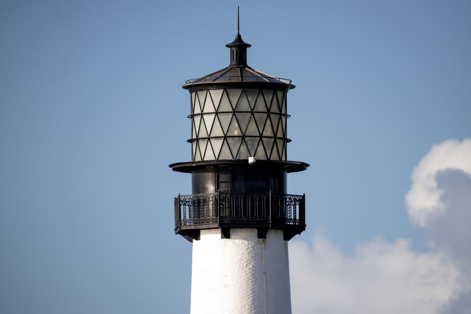 Free Image of Tall lighthouse against a clear blue sky on a sunny day 