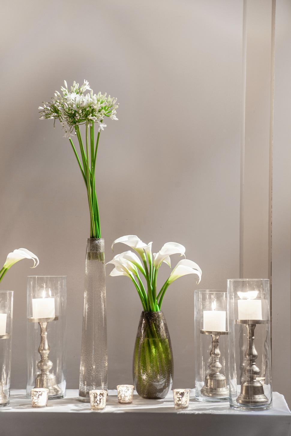 Free Image of Elegant floral arrangement with candles on display in modern setting 