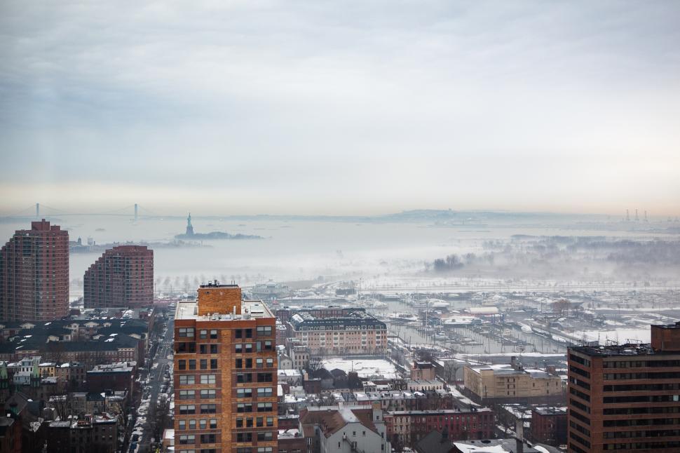 Free Image of Fog blankets New York City with a view of the Statue of Liberty 