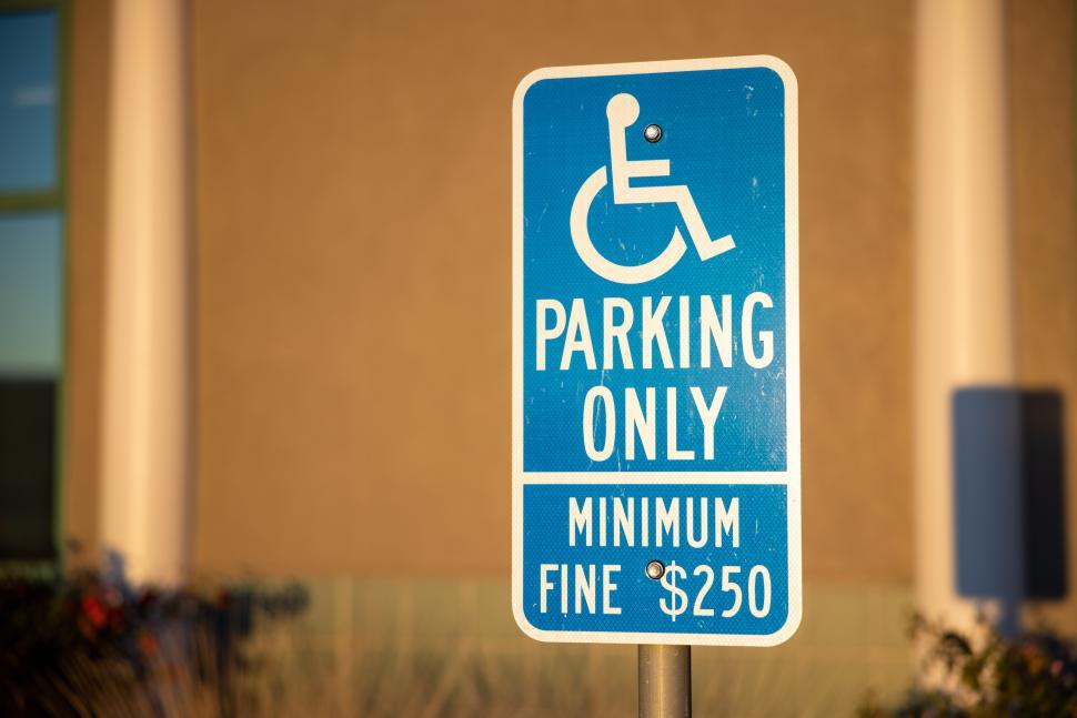 Free Image of Accessible parking sign indicating fine for unauthorized use 