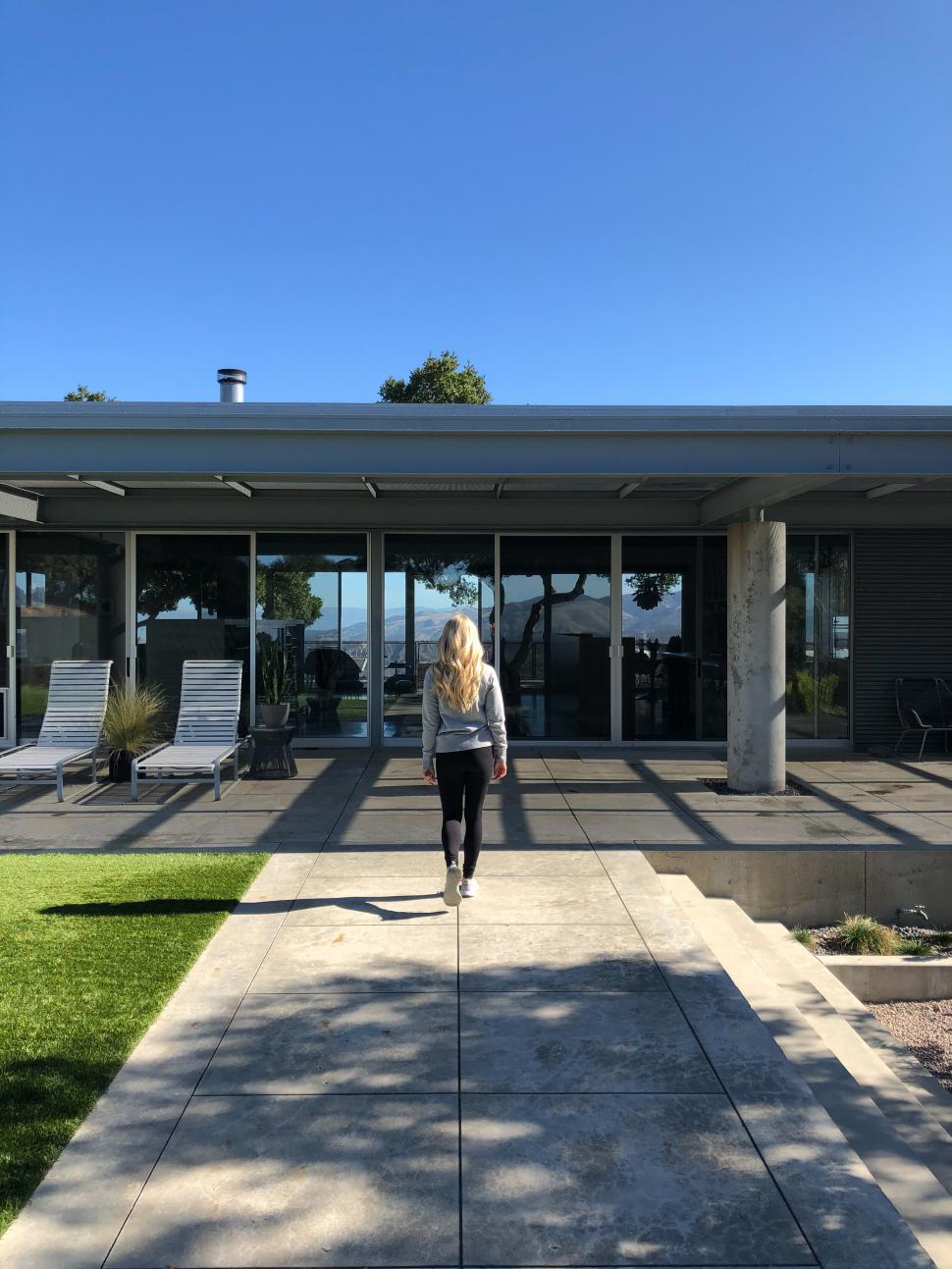 Free Image of Walking towards a modern house with scenic views on a sunny day 