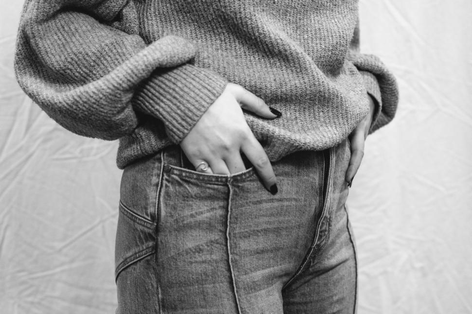 Free Image of Fashionable outfit showcasing a cozy sweater and stylish jeans 