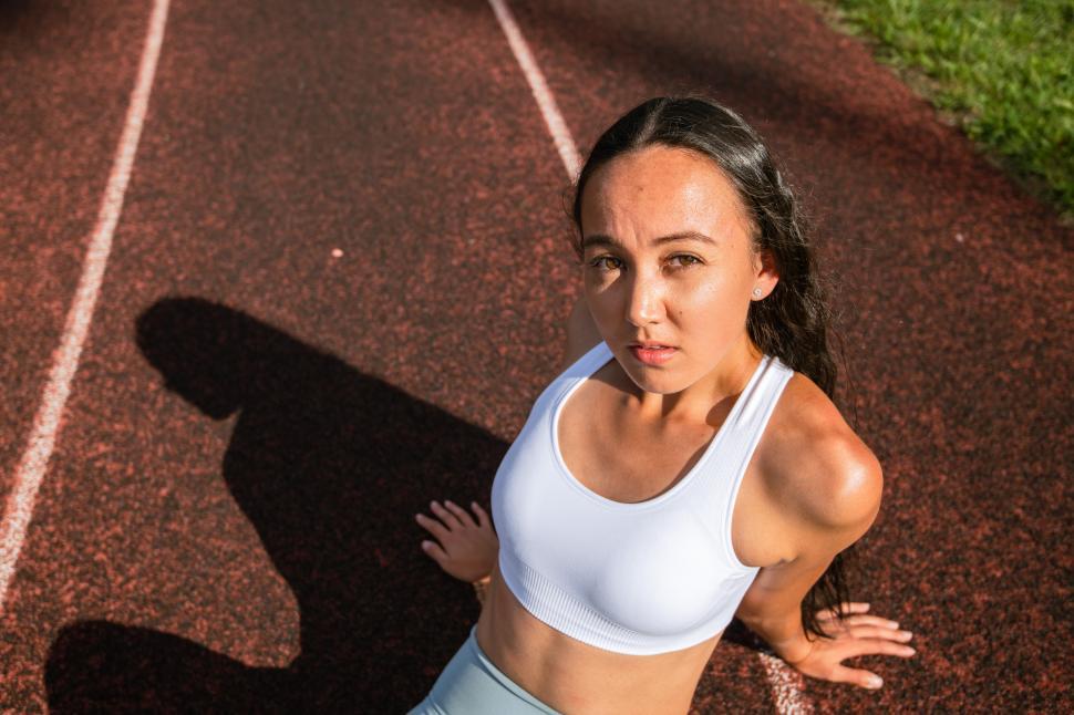 Free Image of Young athlete prepares for training on track field outdoors 