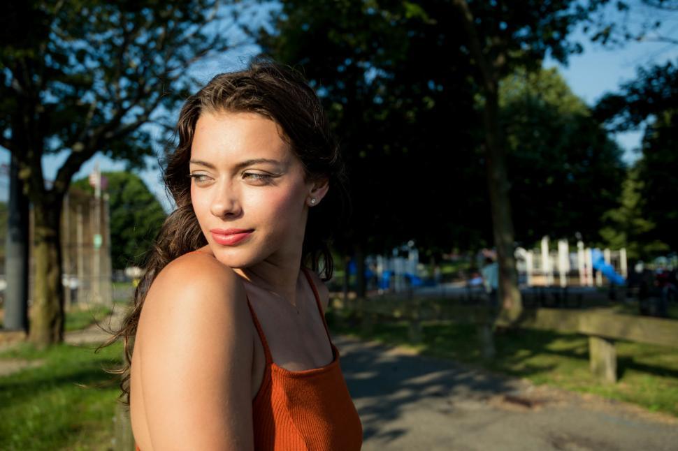 Free Image of Woman enjoying a sunny day at the park in vibrant attire 