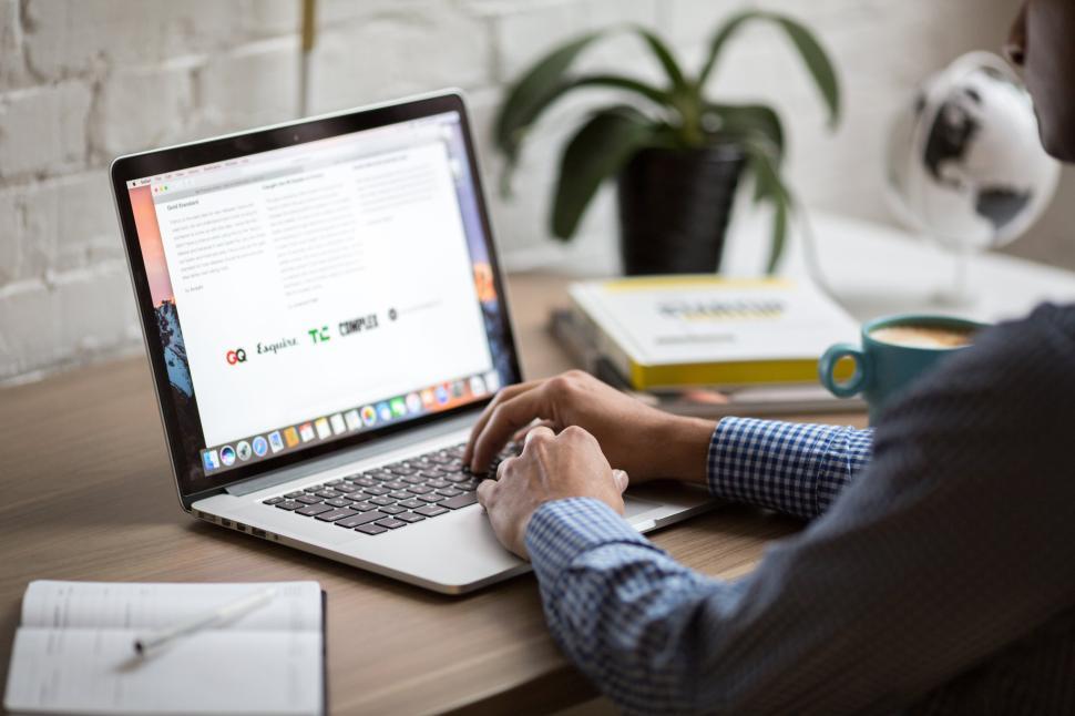 Free Image of Working on laptop at a cozy desk in a bright workspace 