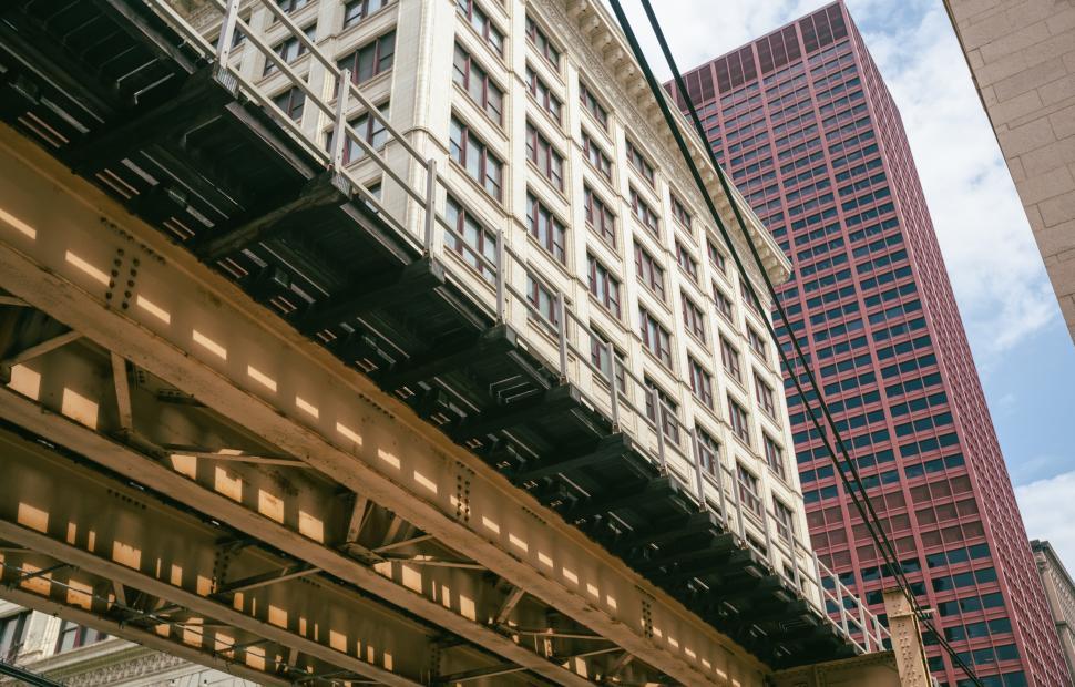 Free Image of Elevated train tracks connect historic and modern buildings 