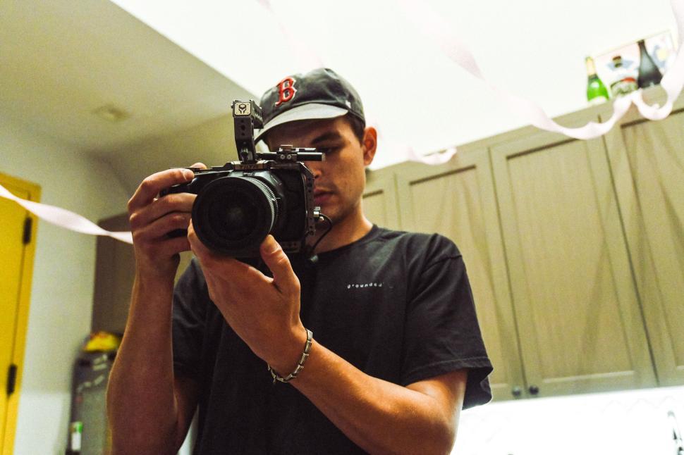 Free Image of Young man taking photos in a creatively decorated kitchen space 
