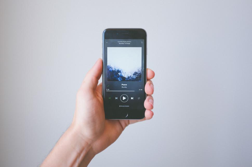 Free Image of Listening to relaxing music on a smartphone in a calm setting 
