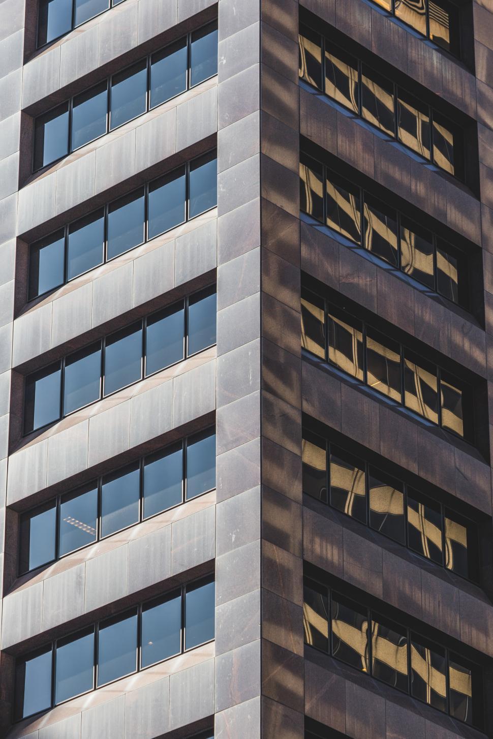 Free Image of Modern office building with reflective windows in sunlight 