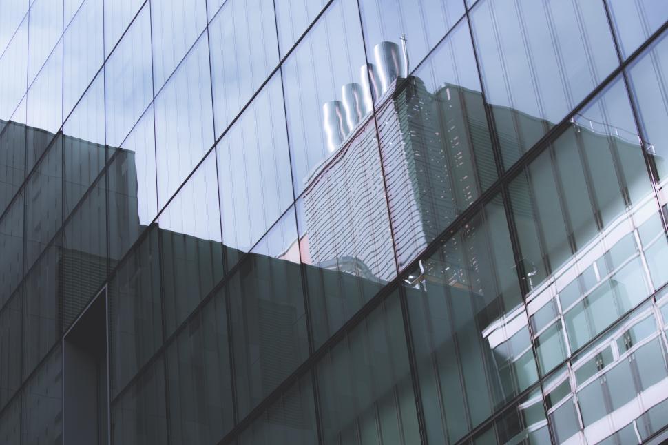 Free Image of Buildings reflecting on modern glass architecture 