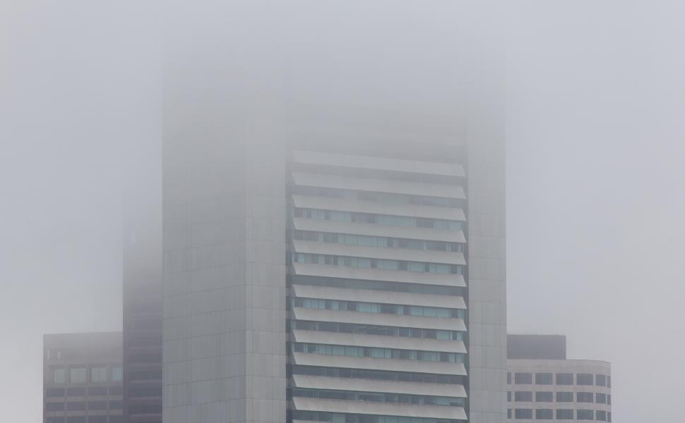Free Image of Fog envelops city buildings creating a mysterious urban atmosphere 