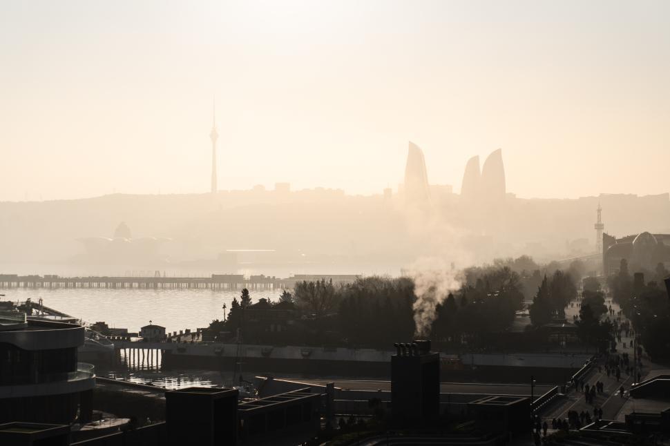 Free Image of Urban cityscape of Baku, Azerbaijan, under a stunning evening sunset, featuring the modern skyline bathed in warm golden light and a vibrant metropolitan atmosphere.  