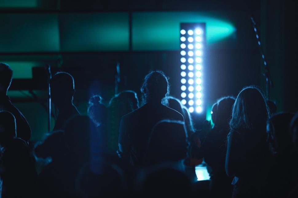 Free Image of Crowd enjoying a live performance under dramatic lighting 