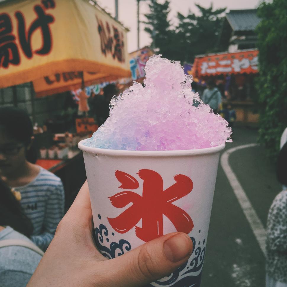 Free Image of Brightly colored snow cone at a lively festival fair 