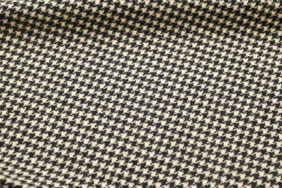 Free Image of Houndstooth fabric displayed on a flat surface in natural lighting 