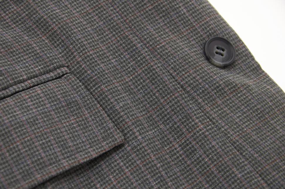 Free Image of Stylish gray suit fabric with detailed patterns and button close up view 