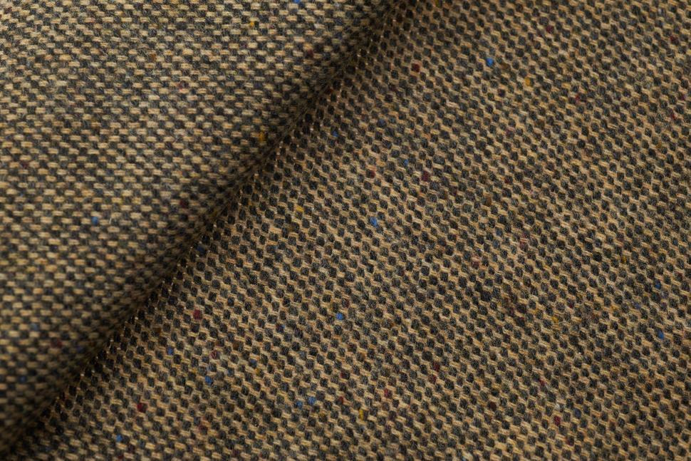Free Image of Textured fabric showcasing a rich blend of earthy hues and intricate patterns 