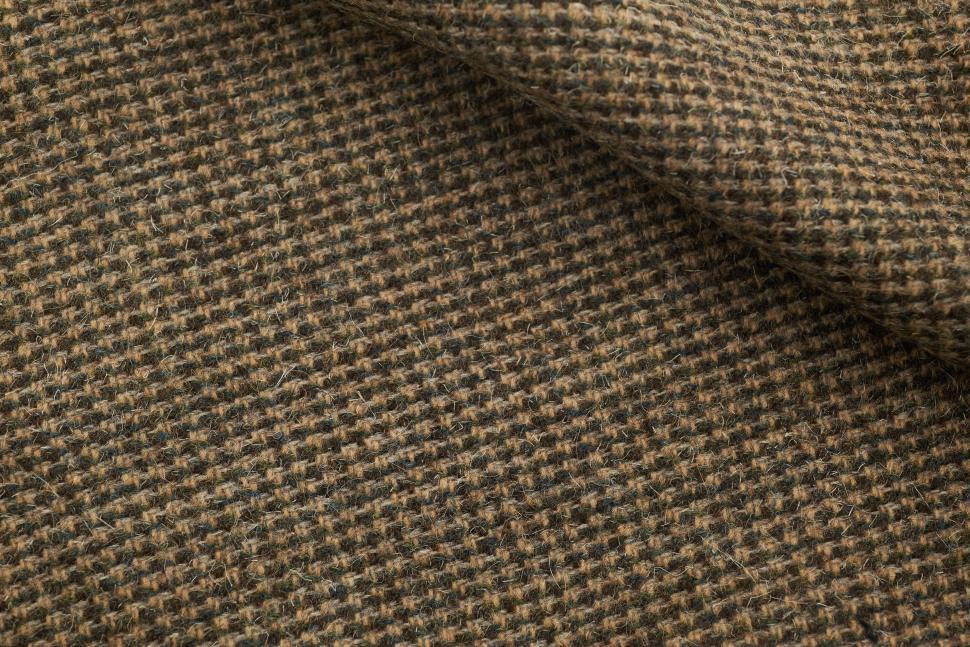 Free Image of Textured fabric showcasing earthy tones and intricate weaving patterns 