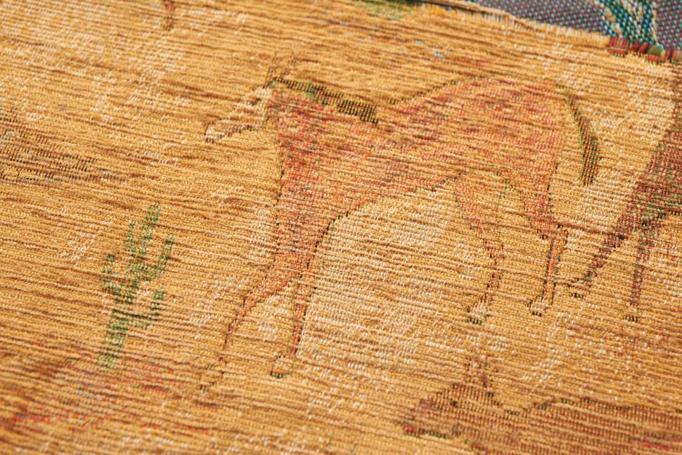Free Image of Ancient textile depicting scenes of animals in rustic earth tones 