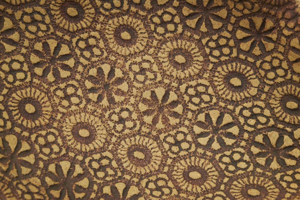 Free Image of Decorative patterns on handcrafted pottery showcasing intricate floral designs 