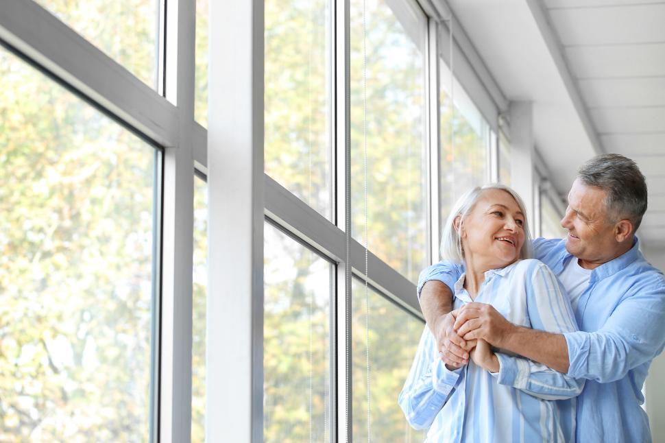 Free Image of Couple enjoying a joyful moment in a sunlit room 