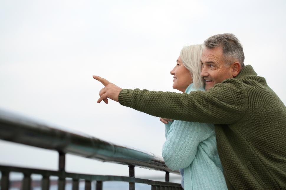 Free Image of Senior couple enjoying time together at a scenic viewpoint 