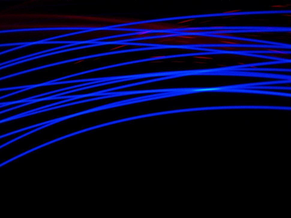 Free Image of Blue Light Streaks on a Black Background 