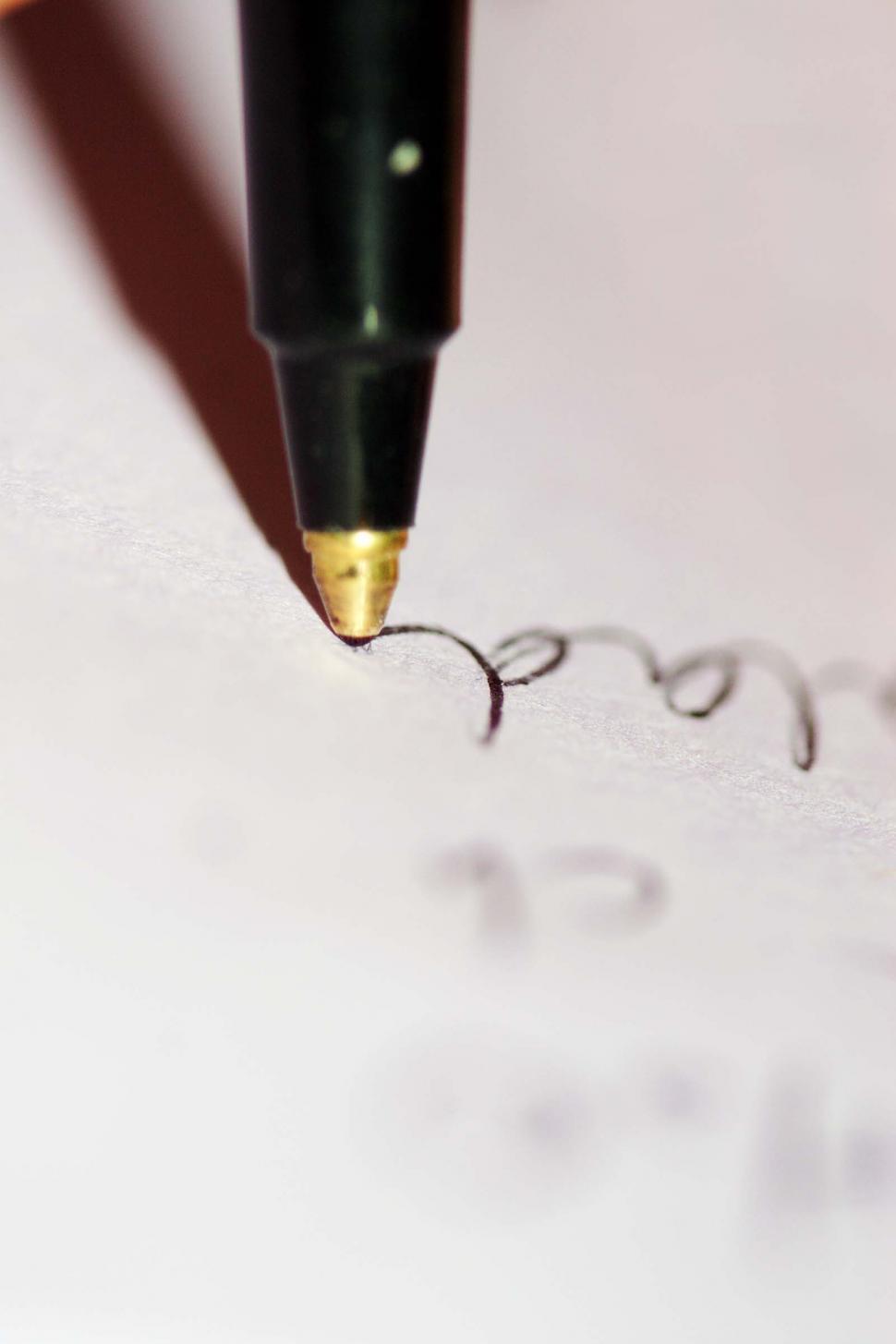 Free Image of Closeup of pen point as writing flows 
