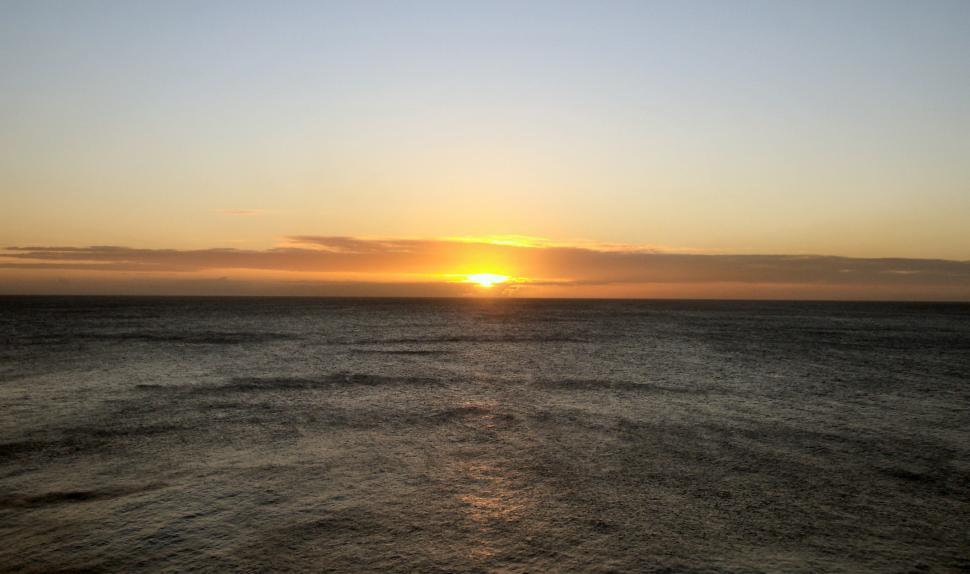 Free Image of Beautiful colorful sunset over the ocean with clouds 