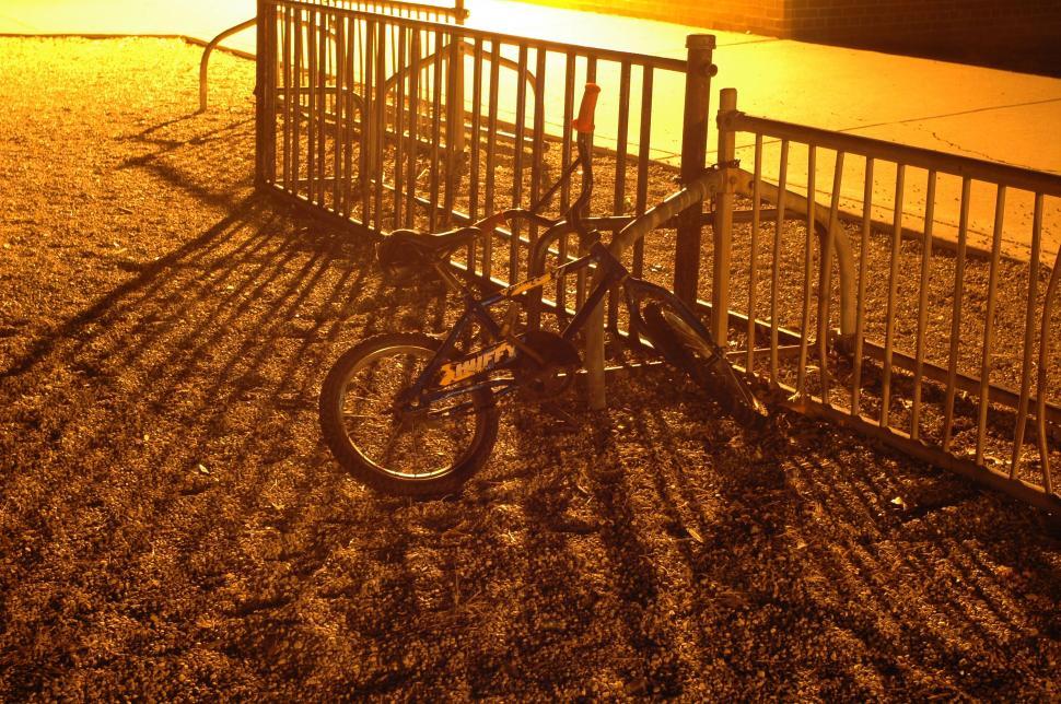 Free Image of Bike Parked Next to Metal Fence 