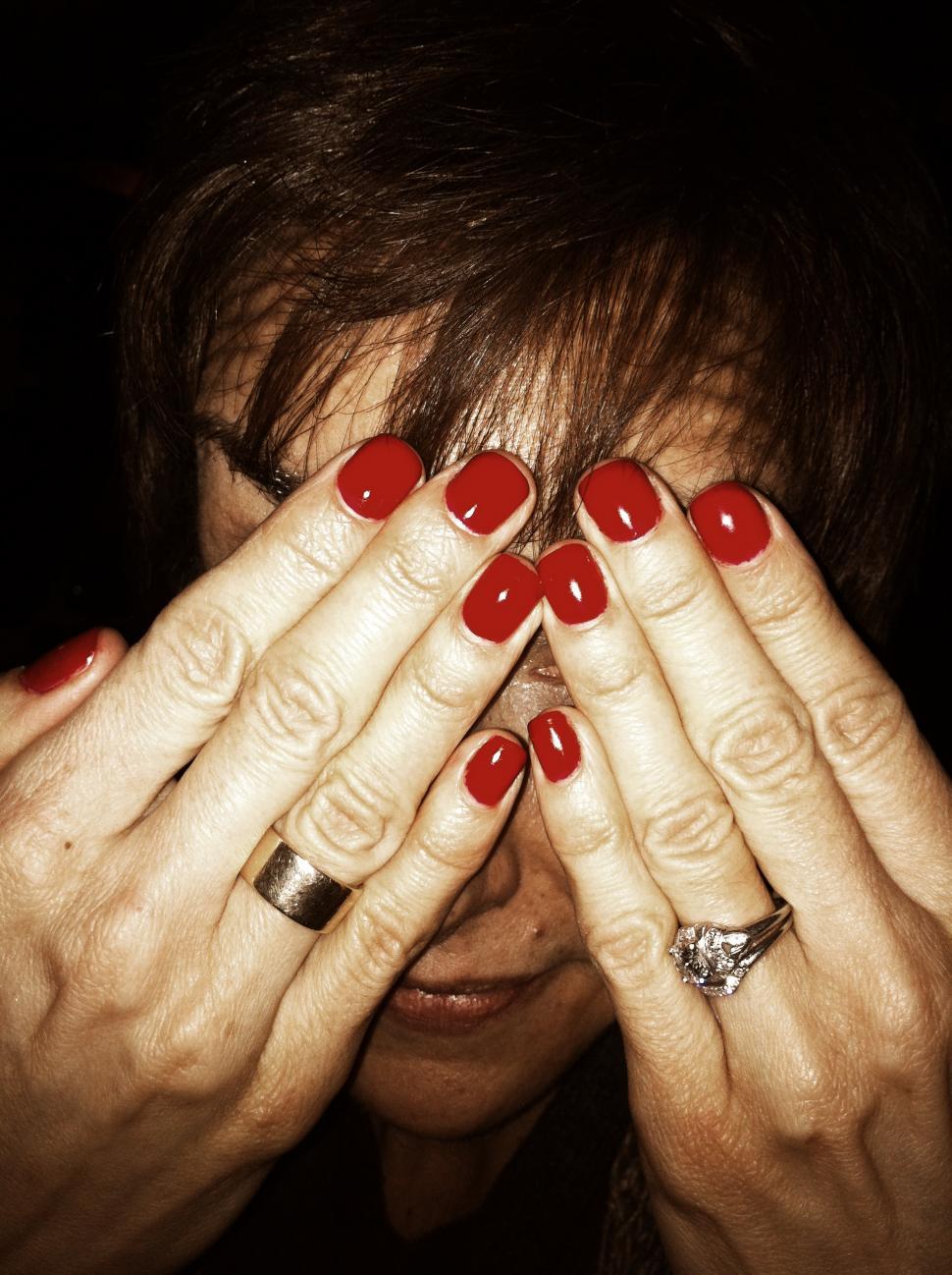 Free Image of Woman Hiding Behind Manicure 