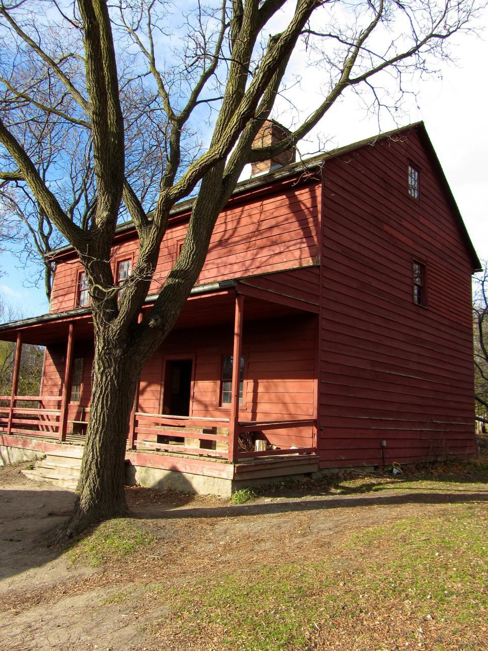 Free Image of Large Red Building Next to Tree 