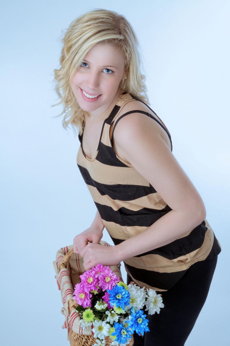 Free Image of Young blonde woman with flower basket 