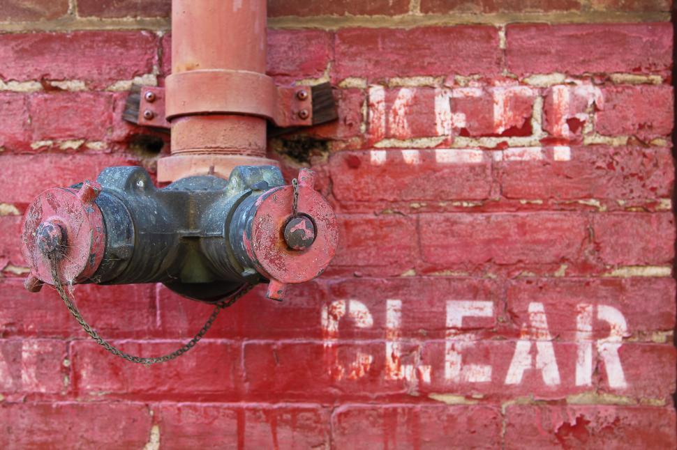 Free Image of Fire Hydrant on a Wall 