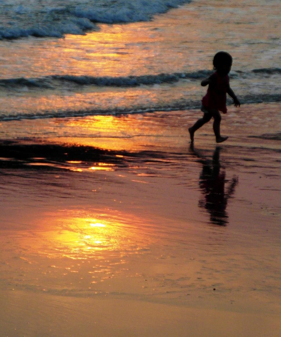 Free Image of Child Running on Beach at Sunset 