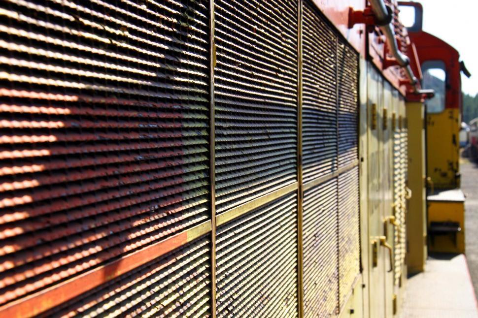 Free Image of Red and Yellow Train Traveling Down Train Tracks 