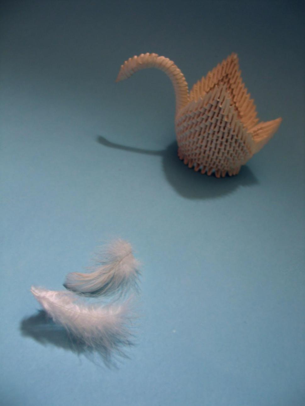 Free Image of Teapot-shaped Artwork With Feather Detail 